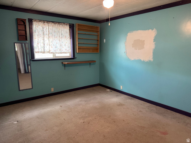 210 South State Street Moroni, UT 84646 - Photo 12 of 23 Room featuring a window, ceiling fan with light fixture, and wall-to-wall carpeting