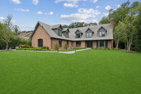 a front view of house with yard and green space
