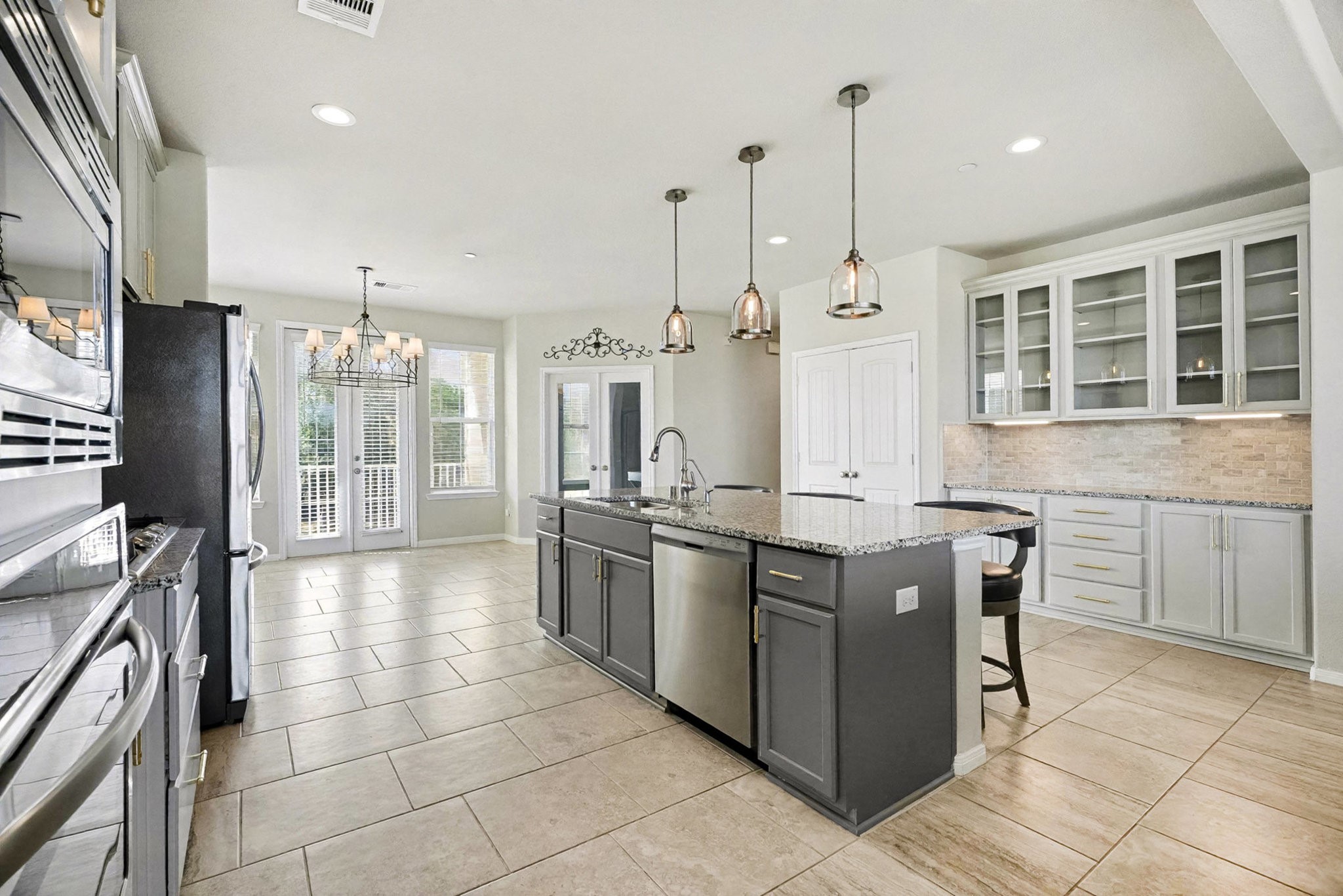 1412 Veranda Mist League City, TX 77573 - Photo 10 of 35 a kitchen with stainless steel appliances granite countertop a stove and a refrigerator