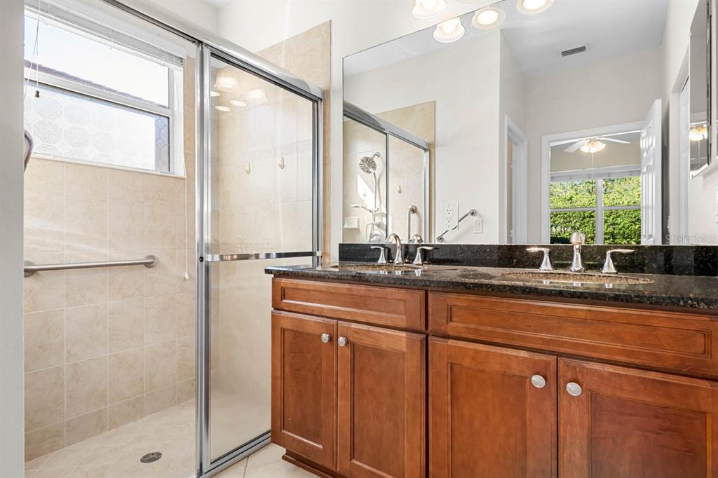 16252 Amethyst Key Drive Wimauma, FL 33598 - Photo 22 of 47 a bathroom with a double vanity sink and a mirror
