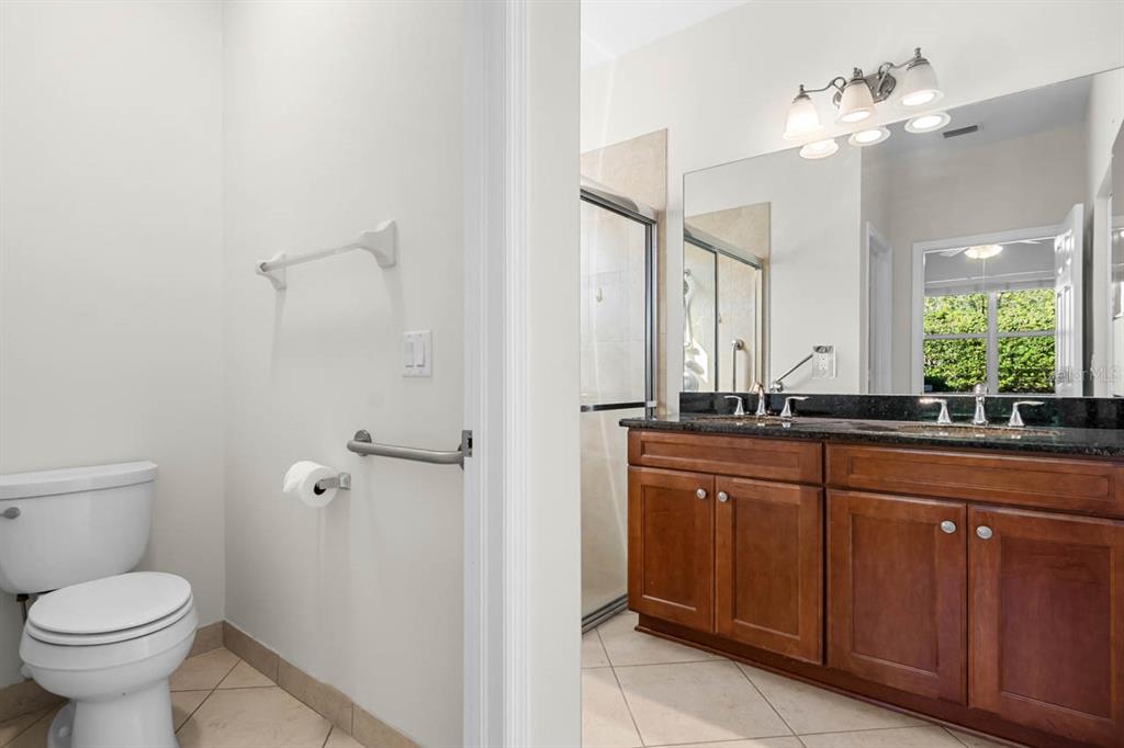 16252 Amethyst Key Drive Wimauma, FL 33598 - Photo 23 of 47 a bathroom with a toilet sink and mirror