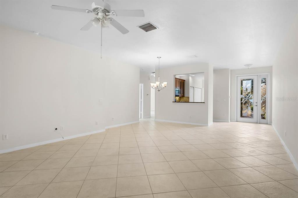 16252 Amethyst Key Drive Wimauma, FL 33598 - Photo 8 of 47 a view of a big room with windows and chandelier fan