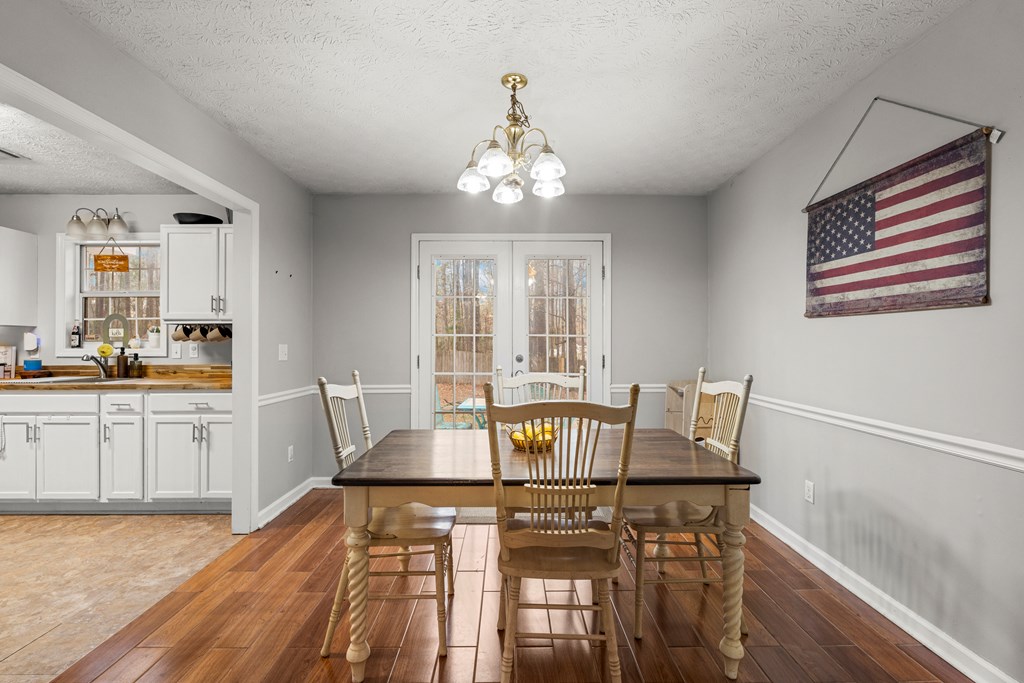 4420 Hudson Mill Road Cataula, GA 31804 - Photo 13 of 25 a view of a dining room with furniture window and wooden floor