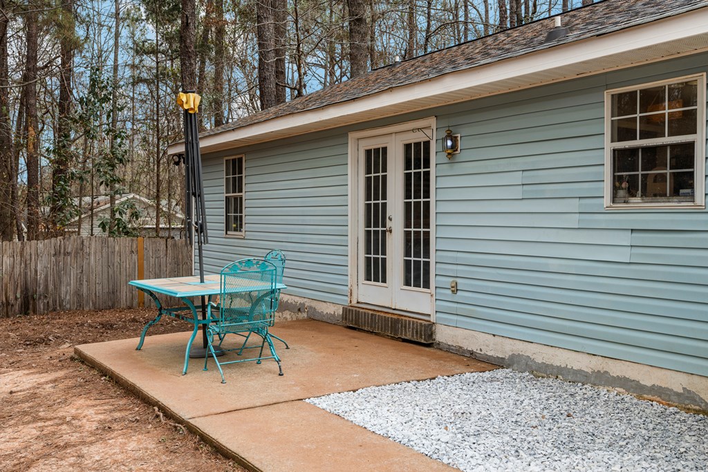 4420 Hudson Mill Road Cataula, GA 31804 - Photo 25 of 25 a view of a patio with a table and chairs and a large tree