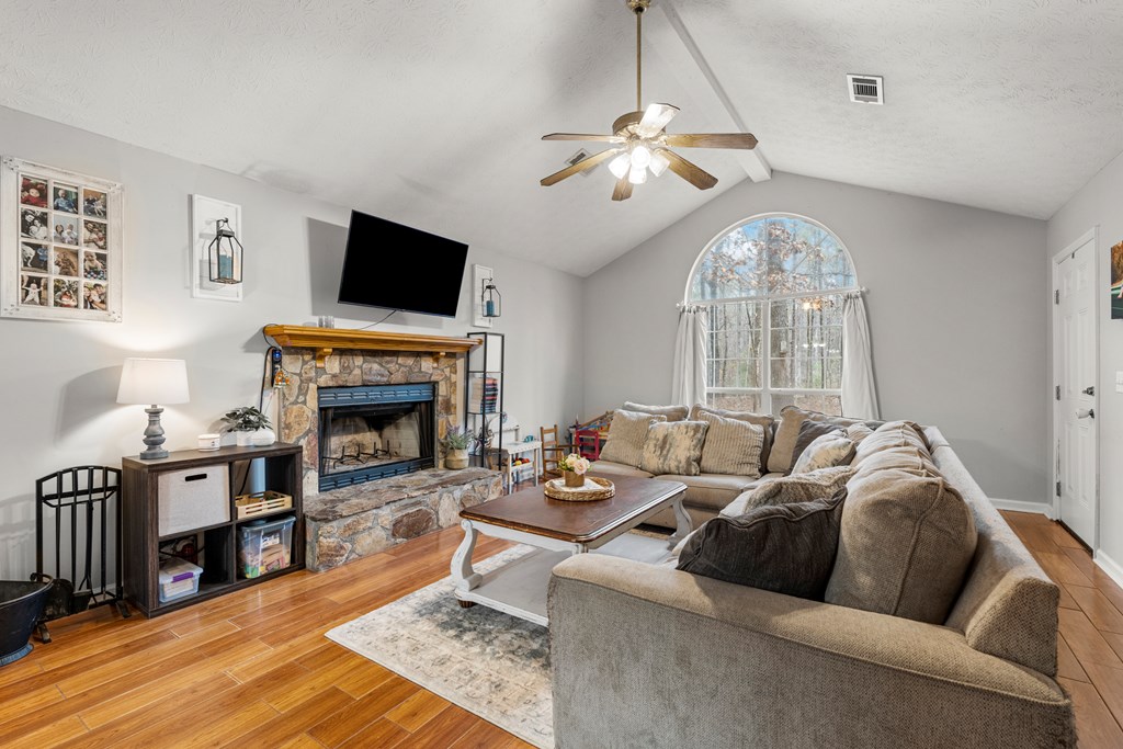4420 Hudson Mill Road Cataula, GA 31804 - Photo 4 of 25 a living room with furniture a fireplace and a flat screen tv