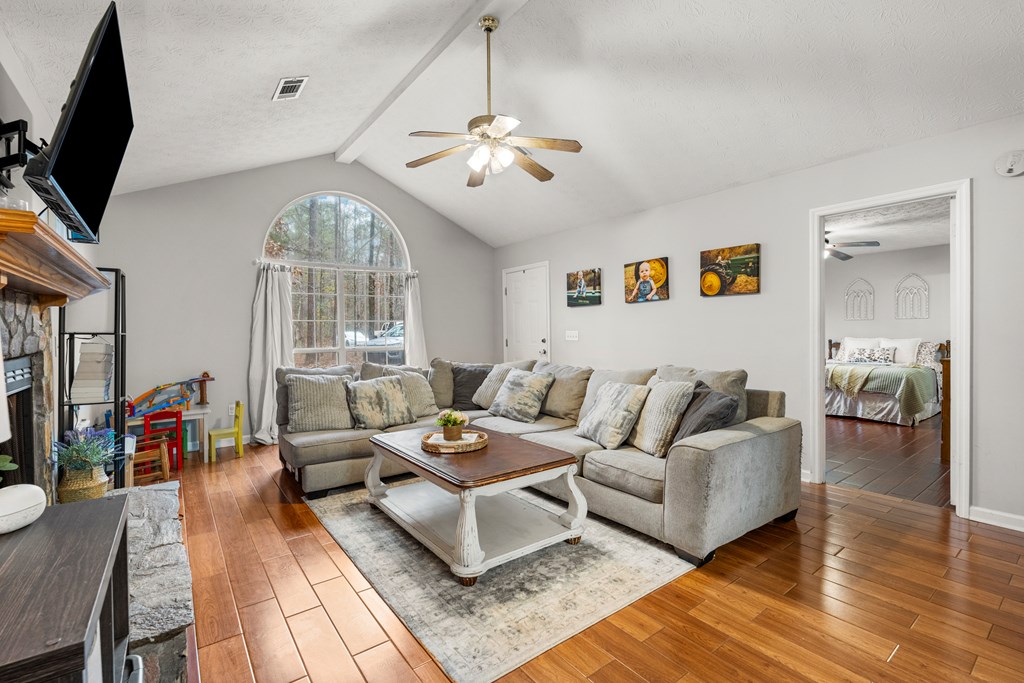 4420 Hudson Mill Road Cataula, GA 31804 - Photo 5 of 25 a living room with furniture a chandelier and a flat screen tv