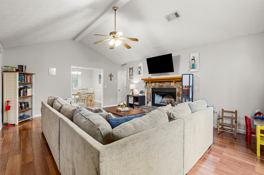 4420 Hudson Mill Road Cataula, GA 31804 - Photo 6 of 25 a living room with furniture a flat screen tv and a fireplace