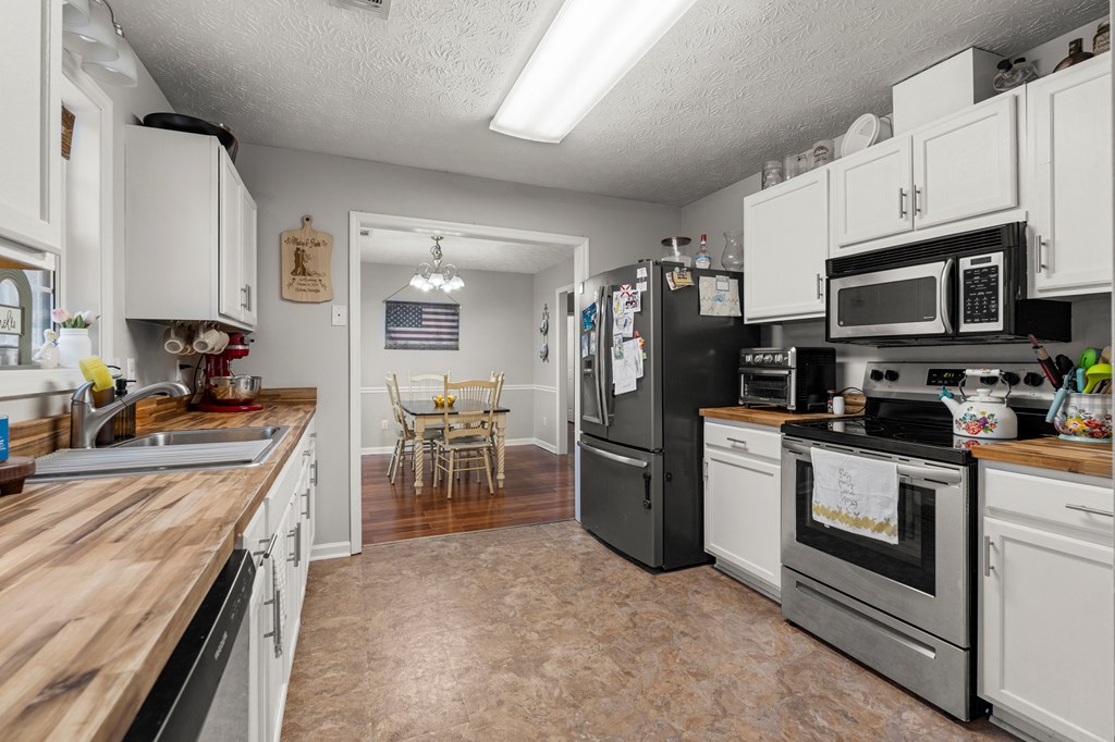 4420 Hudson Mill Road Cataula, GA 31804 - Photo 9 of 25 a kitchen with stainless steel appliances granite countertop a refrigerator stove and sink