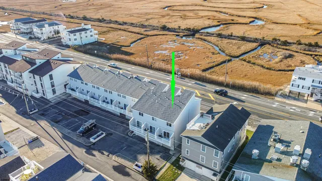 an aerial view of a residential building with an outdoor space