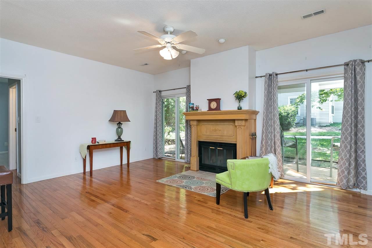 6020 Winterpointe Lane, Unit 101 Raleigh, NC 27606 - Photo 3 of 23 Living Room with hardwood floors and a wood burning fireplace