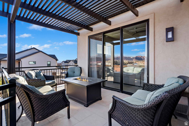2600 Ocotillo Way, Unit 31 Santa Clara, UT 84765 - Photo 36 of 73 Outdoor patio featuring a slatted pergola, tile flooring, and a black metal railing