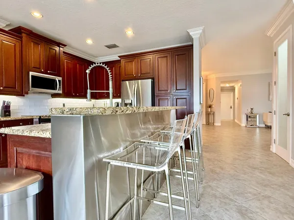 a kitchen with stainless steel appliances granite countertop wooden cabinets a stove top oven a sink and dishwasher