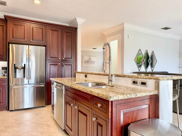 a kitchen with stainless steel appliances kitchen island granite countertop a cabinets and a sink