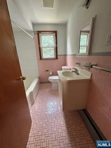a bathroom with a sink toilet and mirror