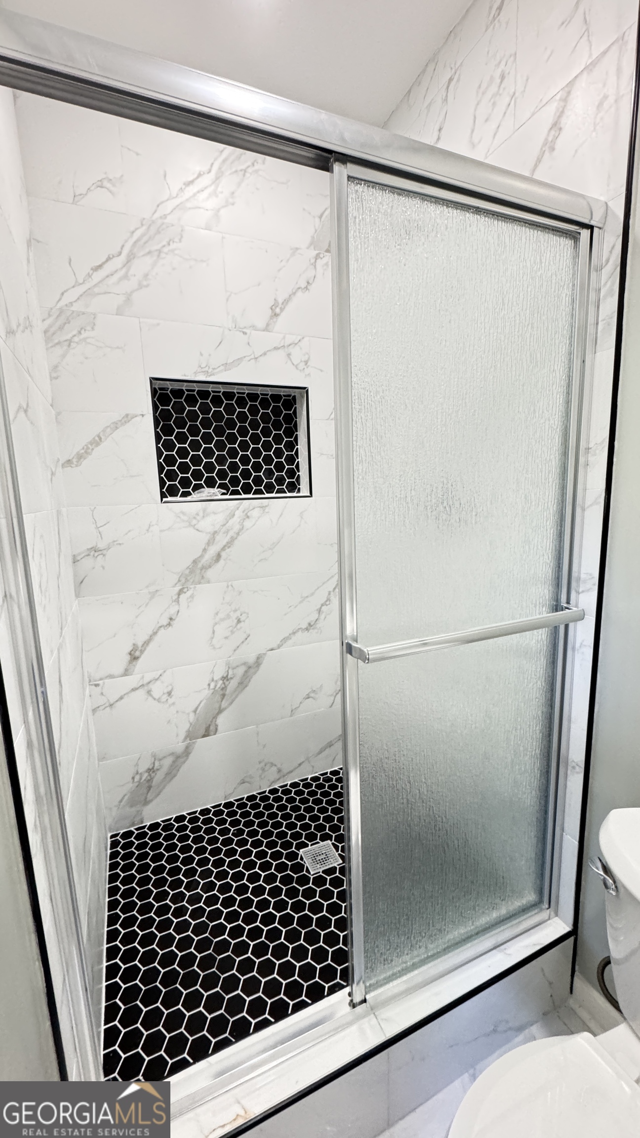 723 Sheffield Road Norcross, GA 30071 - Photo 5 of 8 a bathroom with a shower and a sink