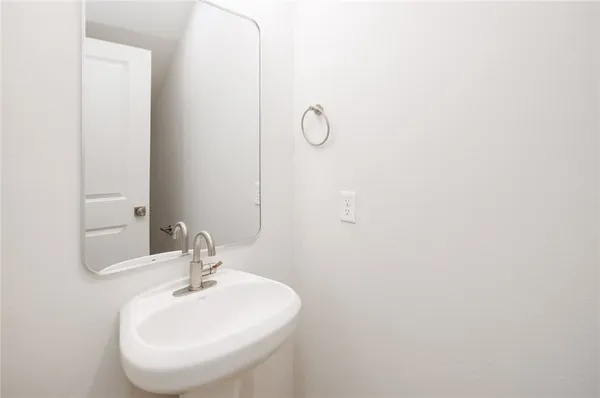 a bathroom with a sink and mirror