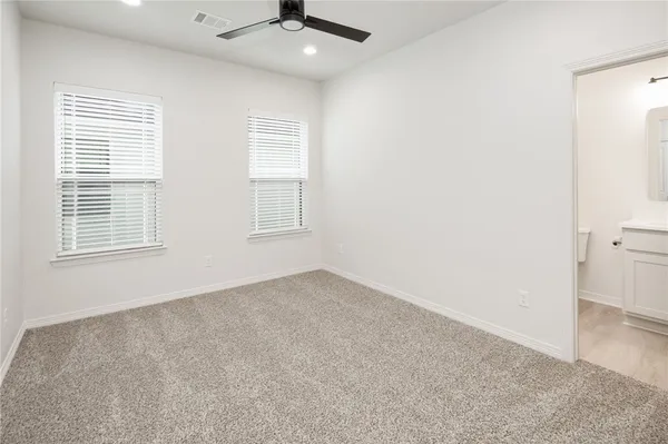 an empty room with windows and closet