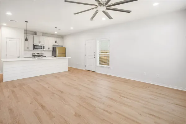 a view of a kitchen with microwave and cabinets