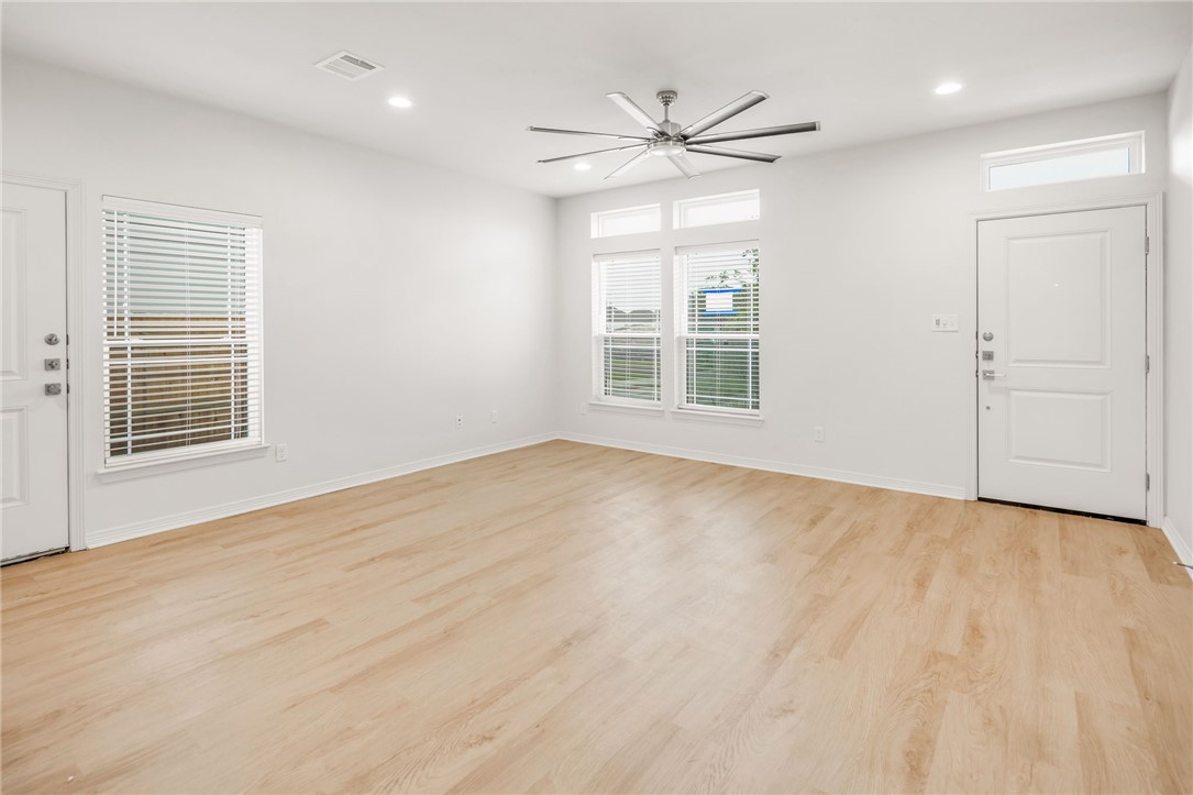412 Ash Street College Station, TX 77840 - Photo 6 of 21 a view of an empty room with a window and wooden floor
