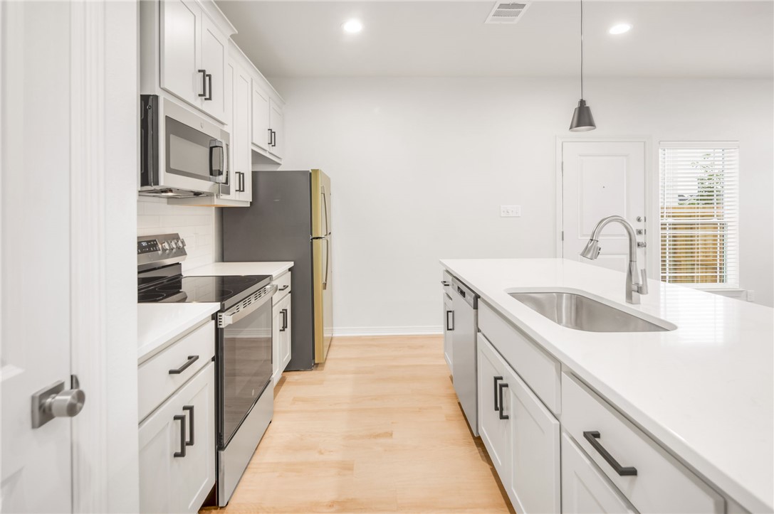 412 Ash Street College Station, TX 77840 - Photo 10 of 21 a kitchen with stainless steel appliances granite countertop a sink stove and refrigerator