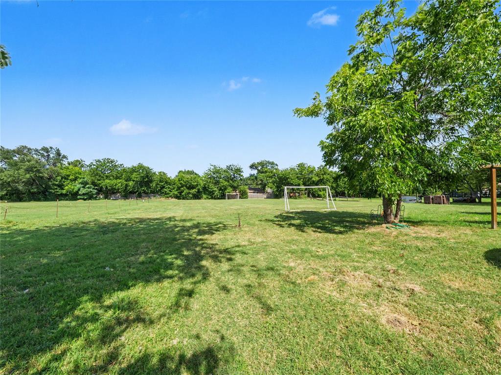 6701 Nauert Road Forest Hill, TX 76140 - Photo 40 of 40 Expansive green space featuring mature trees and a clear blue sky