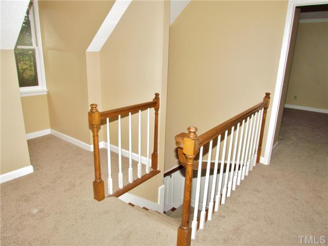 5000 Holly Ridge Farm Road Raleigh, NC 27616 - Photo 15 of 25 a view of staircase with lots of frames on wall and a window
