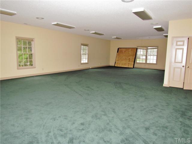 5000 Holly Ridge Farm Road Raleigh, NC 27616 - Photo 23 of 25 en empty room with windows and cabinet
