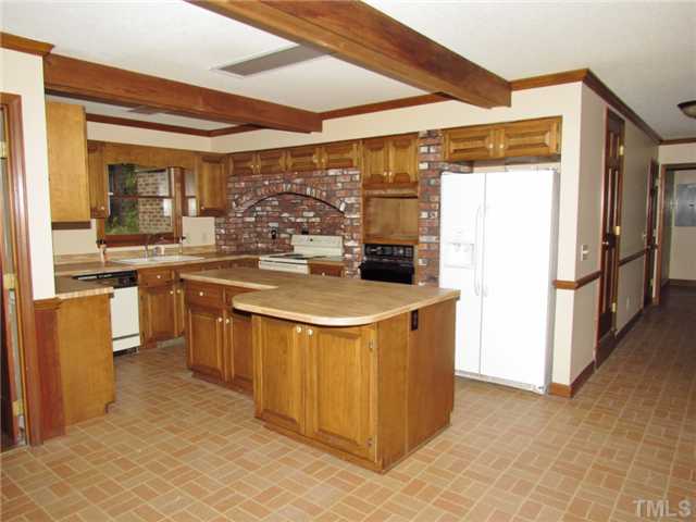 5000 Holly Ridge Farm Road Raleigh, NC 27616 - Photo 4 of 25 a kitchen with stainless steel appliances granite countertop a refrigerator a sink and a stove