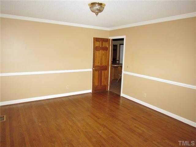 5000 Holly Ridge Farm Road Raleigh, NC 27616 - Photo 5 of 25 a view of an empty room with wooden floor