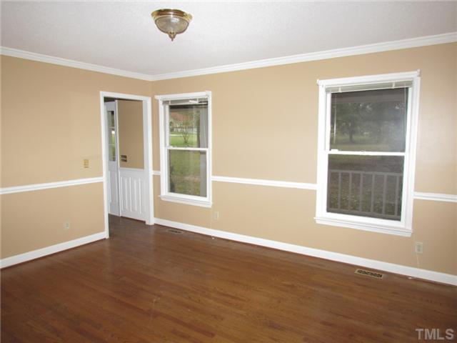 5000 Holly Ridge Farm Road Raleigh, NC 27616 - Photo 6 of 25 a view of an empty room with wooden floor and a window