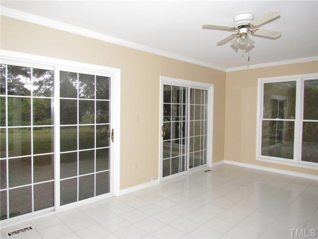 5000 Holly Ridge Farm Road Raleigh, NC 27616 - Photo 9 of 25 a view of an empty room with a window and a ceiling fan