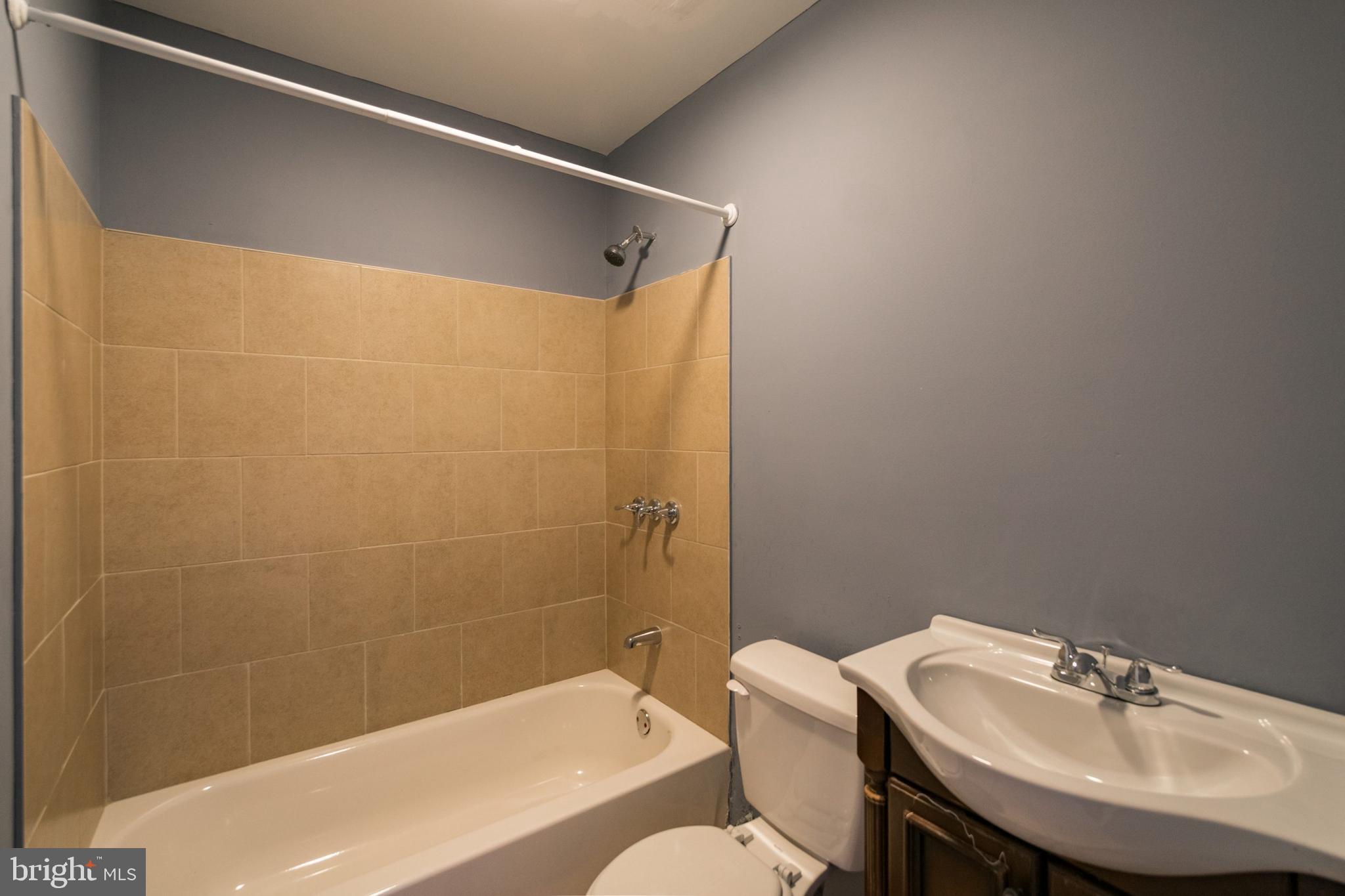 1833 South 22nd Street, Unit 2 Philadelphia, PA 19145 - Photo 13 of 15 a bathroom with a sink and a mirror