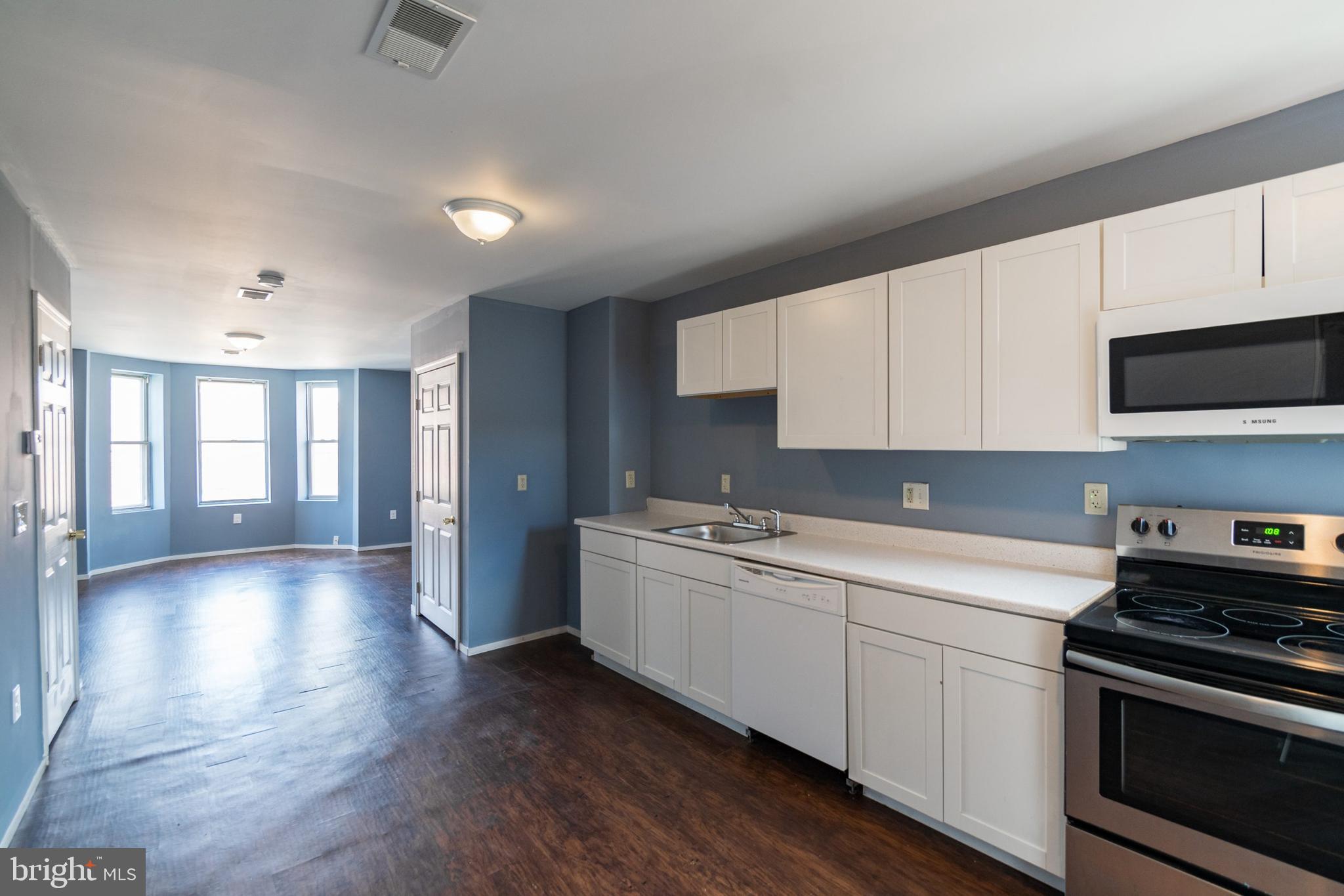 1833 South 22nd Street, Unit 2 Philadelphia, PA 19145 - Photo 2 of 15 a kitchen with a sink stove and cabinets