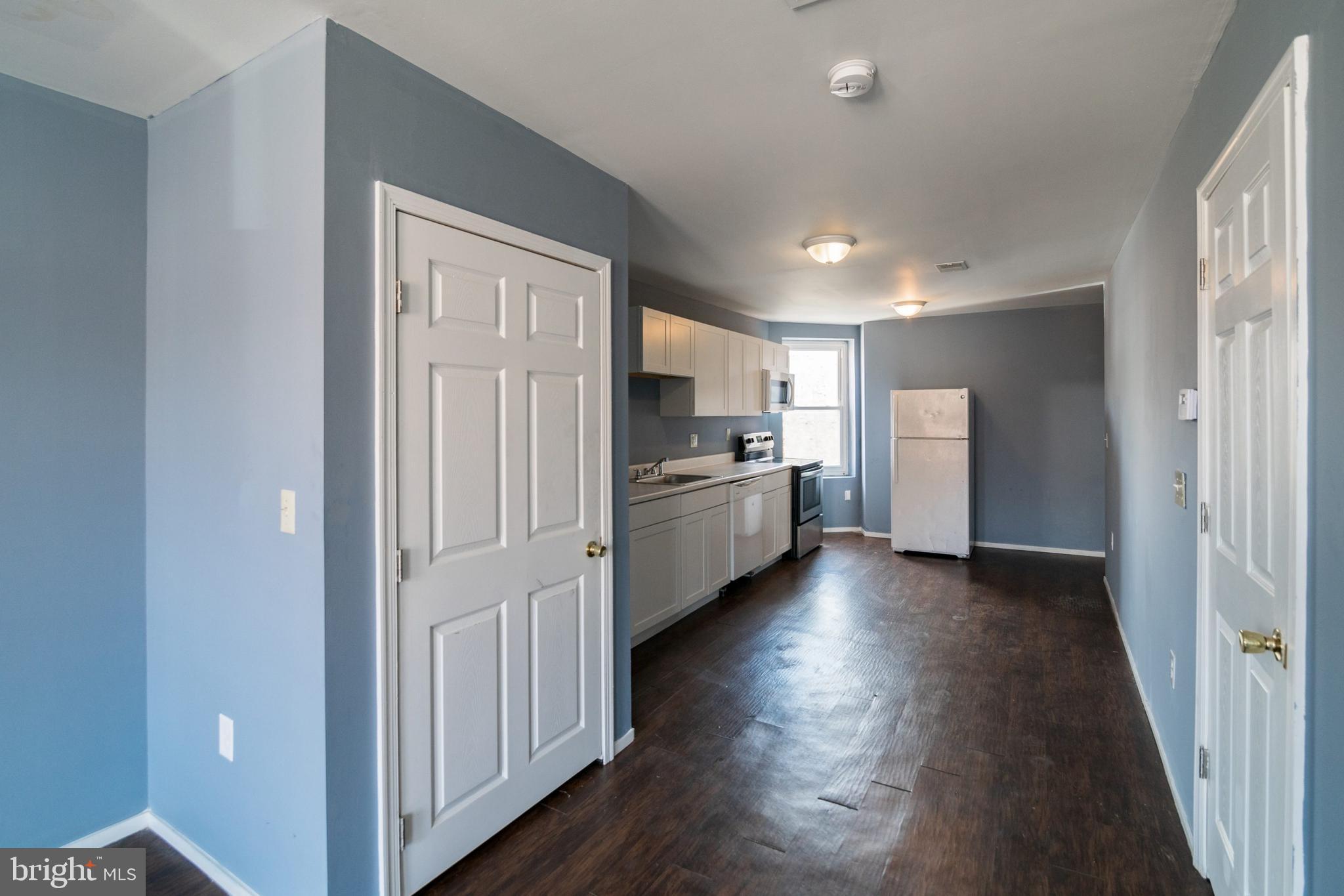 1833 South 22nd Street, Unit 2 Philadelphia, PA 19145 - Photo 3 of 15 a view of a kitchen with refrigerator and wooden floor
