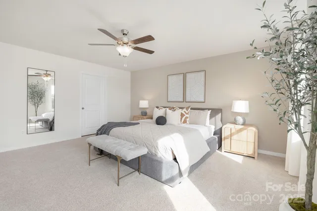 a bedroom with a bed couch and a large window