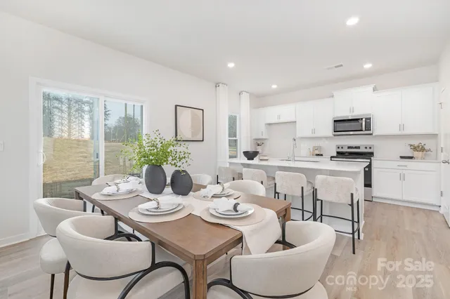 a kitchen with kitchen island a sink counter and chairs