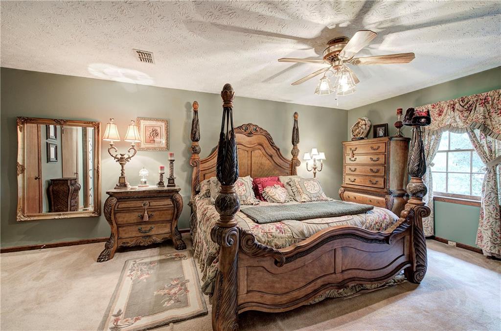 3637 Nebo Road Hiram, GA 30141 - Photo 33 of 63 a bedroom with a bed and a chandelier