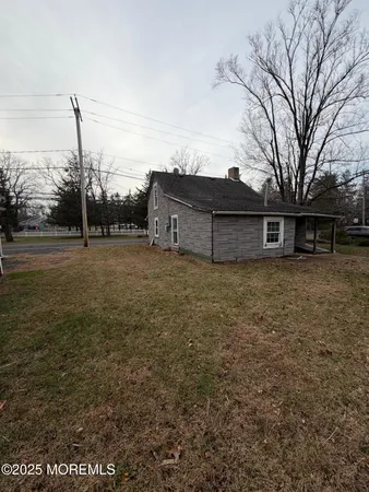 a view of a large house with a big yard and large trees
