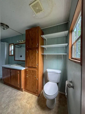 a kitchen with refrigerator cabinets and wooden floor