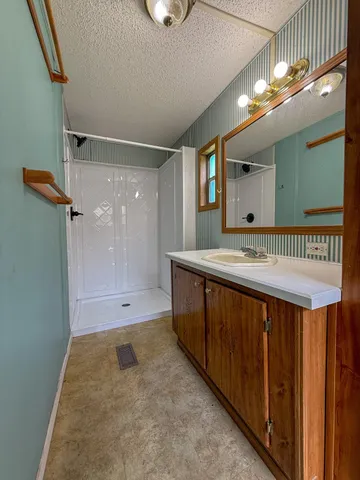 a bathroom with a glass shower door