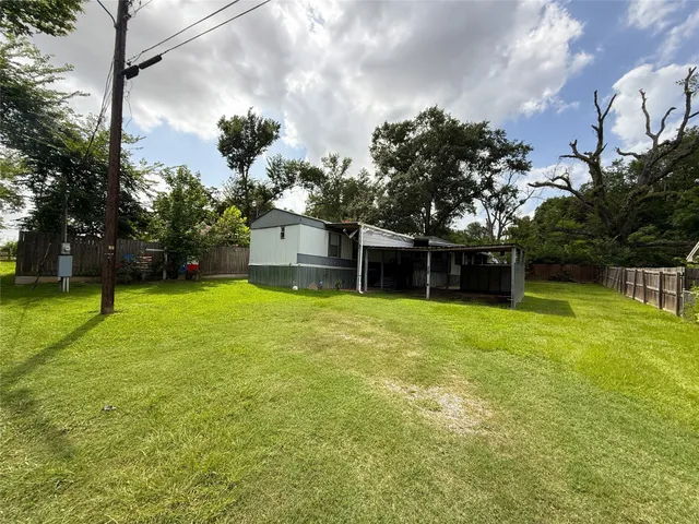 a backyard of a house with lots of green space