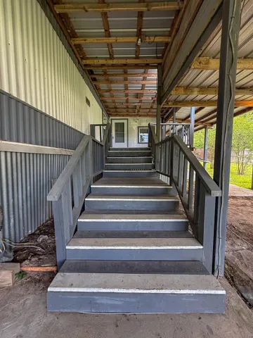 a view of balcony with wooden floor