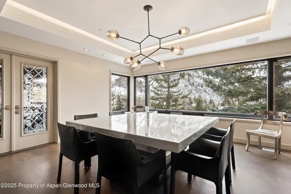 a dining room with furniture and a rug
