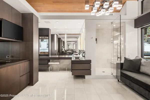 a bedroom with a bed a dresser and a large mirror