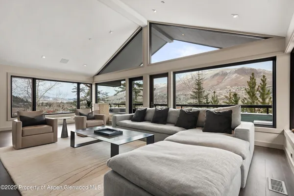 a spacious bedroom with a large bed and a large window