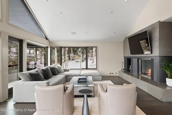 a bedroom with a bed and a view of living room