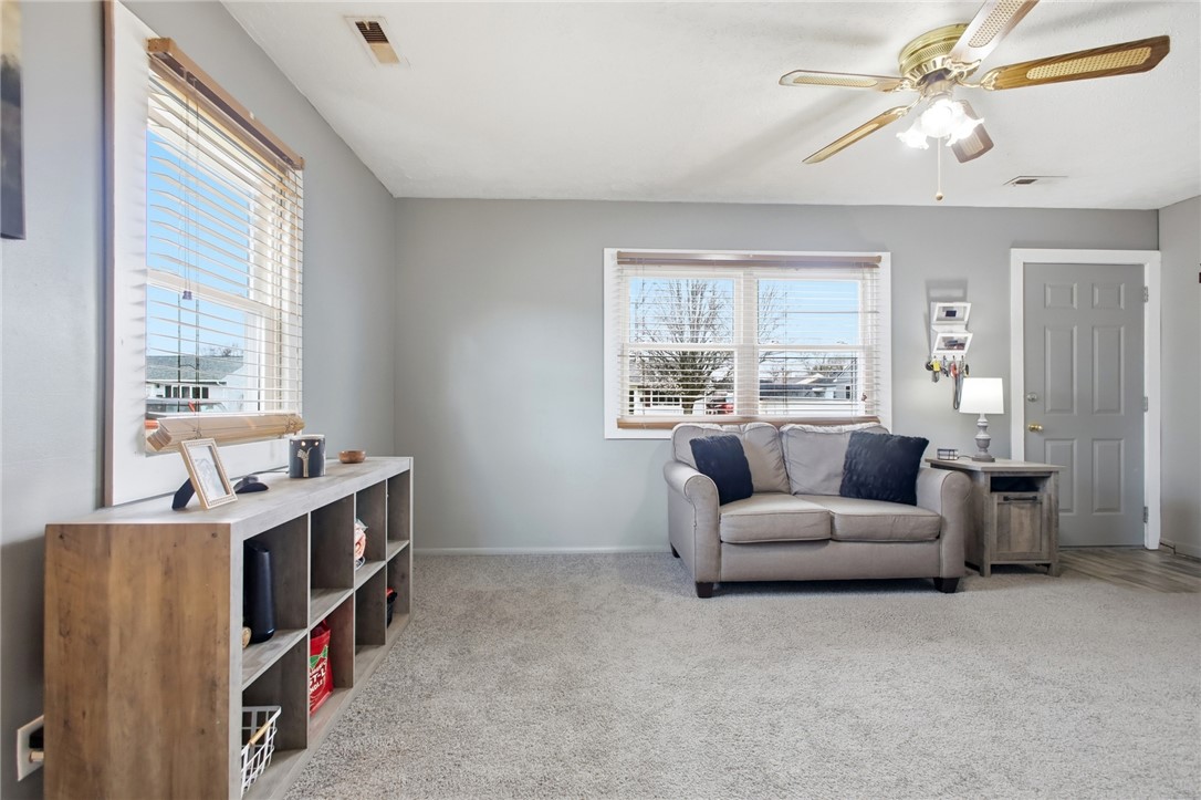 2745 Share Street Springfield, OH 45505 - Photo 6 of 28 This inviting living room features a ceiling fan, plush carpeting, and abundant natural light.