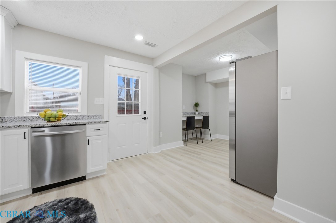 733 Spruce Street Hampton, VA 23661 - Photo 11 of 29 Kitchen with stainless steel appliances, light wood-style floors, white cabinets, light stone countertops, and recessed lighting