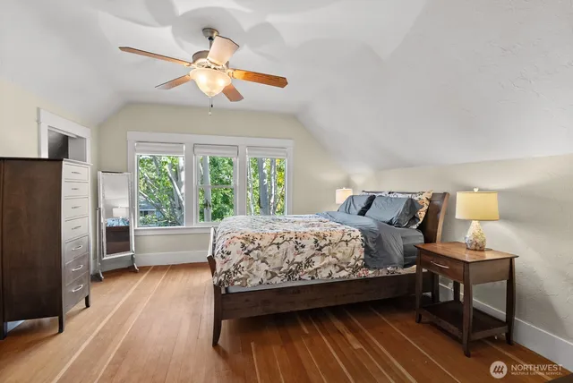 a bedroom with a bed and a large window