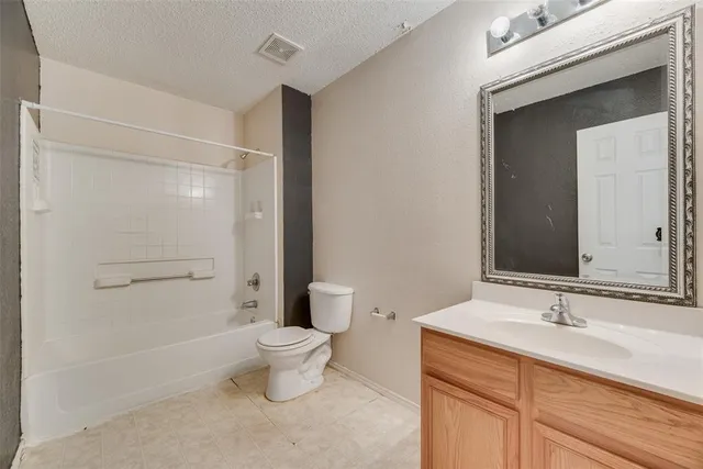 a kitchen with a refrigerator a sink and cabinets